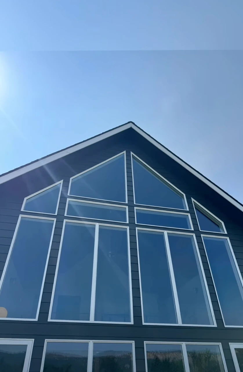 Freshly washed gable and tall windows on a North Idaho home